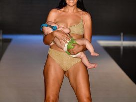 Reactions of people on model walking ramp while breastfeeding baby