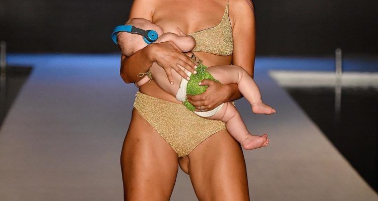 Reactions of people on model walking ramp while breastfeeding baby